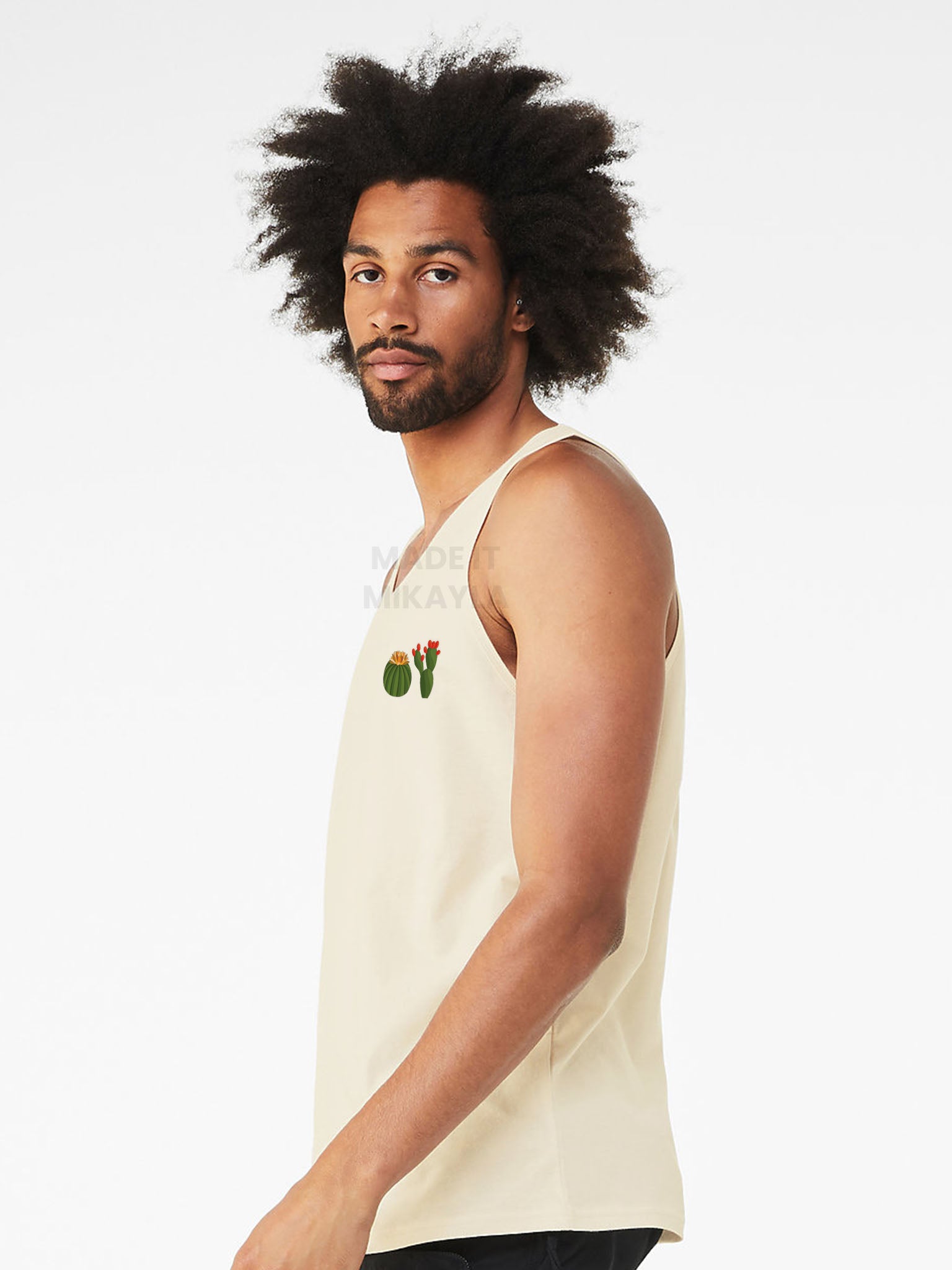Person wearing a beige tank top with a cactus design on a white background
