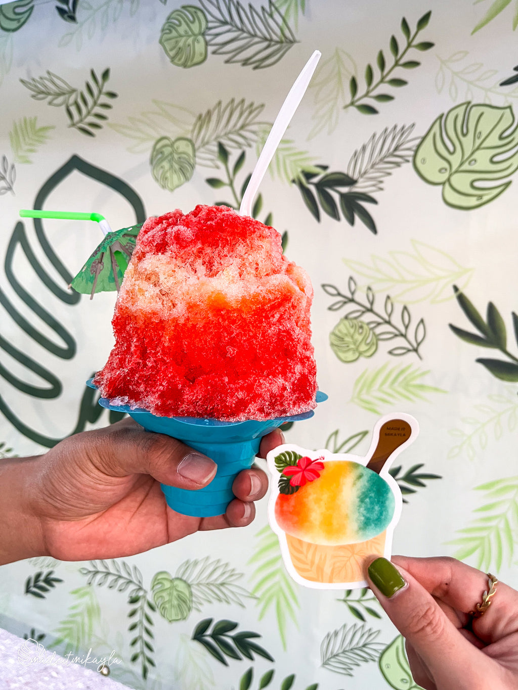 Shave Ice sticker held next to a red and white shave ice treat.