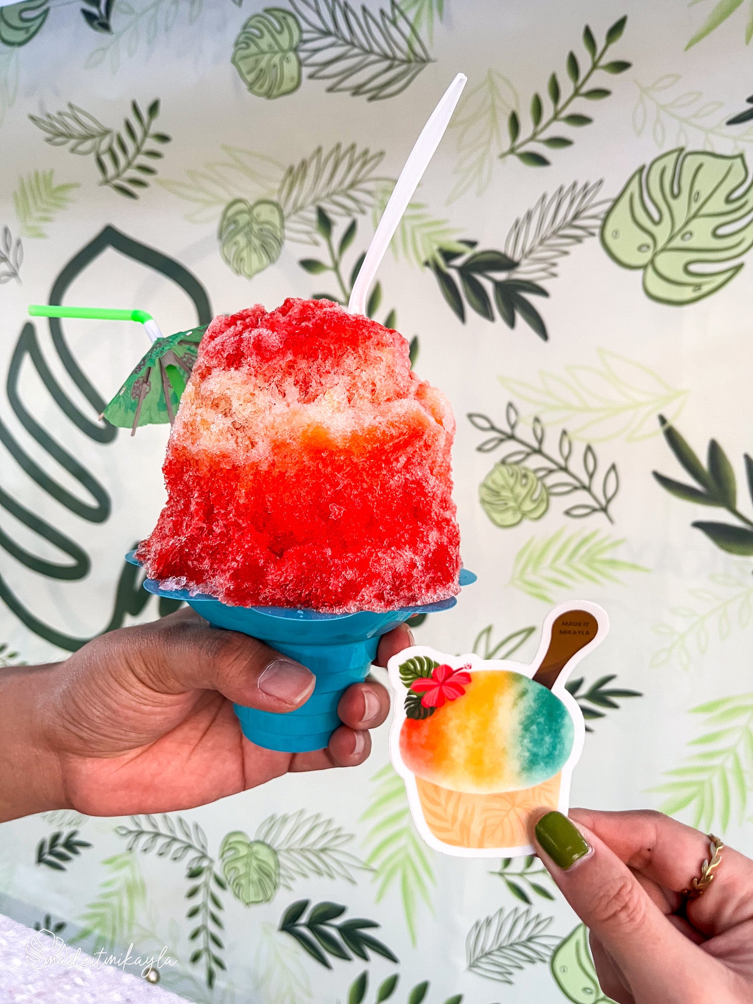 Shave Ice sticker held next to a red and white shave ice treat.