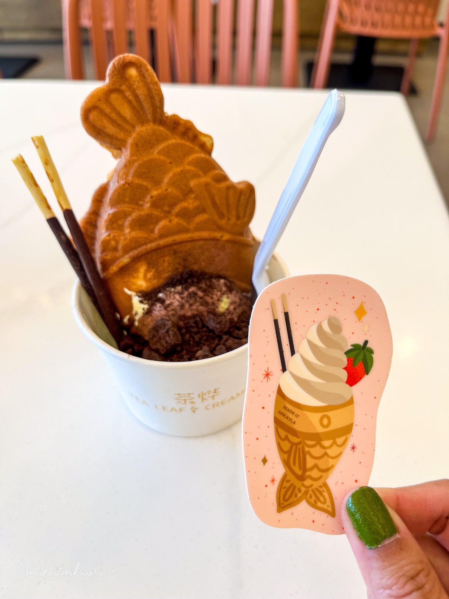 Taiyaki sticker held by a taiyaki ice cream treat.