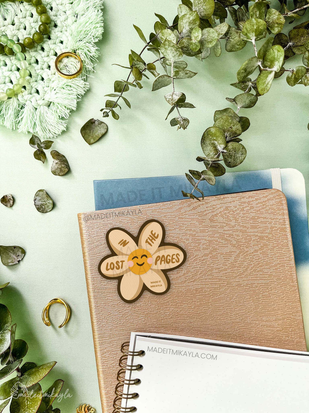 Sticker featuring a cute flower with page texture, with text 'lost in the pages' on the petals.