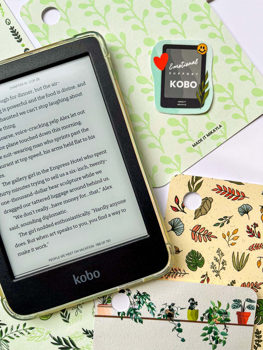 Kobo e-reader laying on top of colorful planty e-reader inserts.